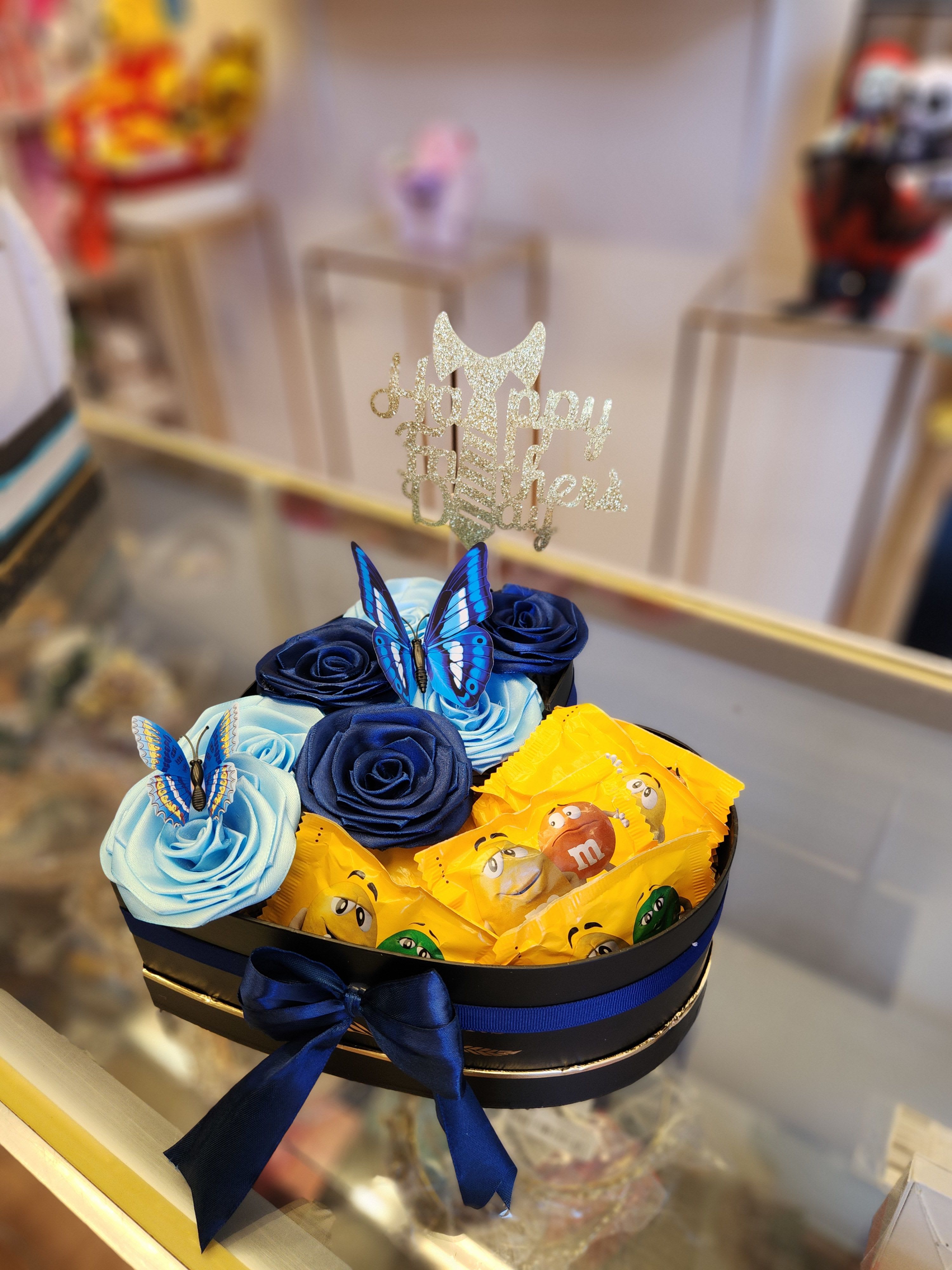 Gift box with satin roses, butterflies, and candy bars