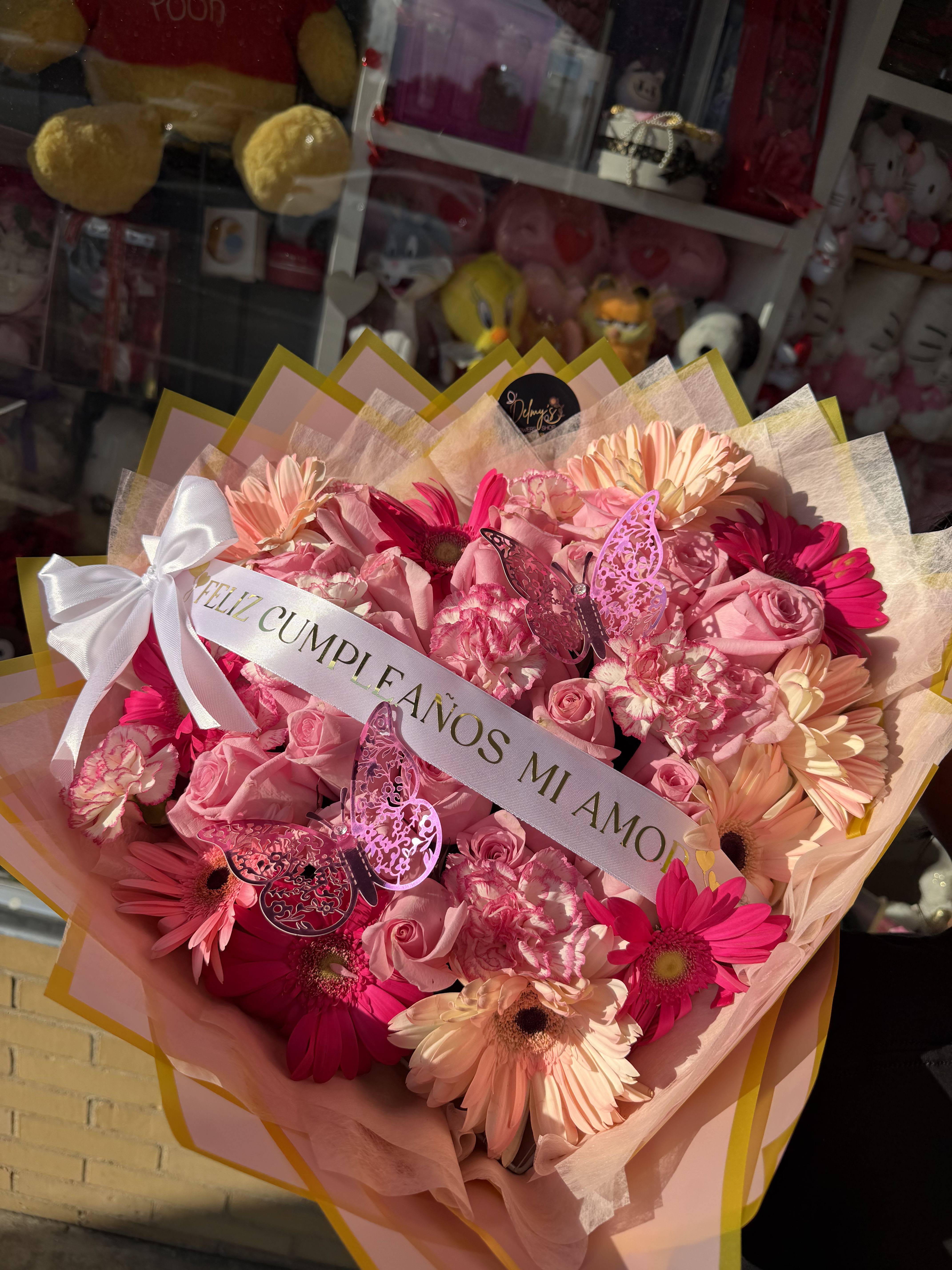 BLUSHING HEART - A BEAUTIFUL WRAPPED BOUQUET MIXED WITH DIFFERENT SHADES OF PINK WHITE AN RED FLOWERS WITH A BANNER WITH YOUR OWN WORDS SHOW YOUR LOVE 