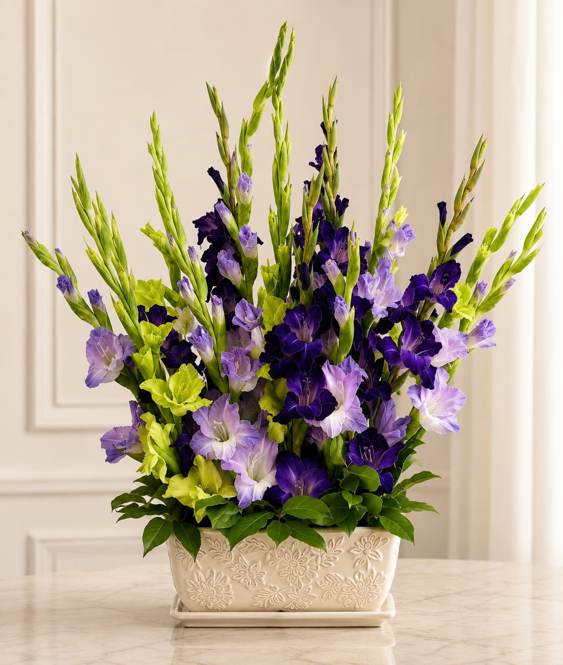 Purple Gladiolus - Please Note: We may use a different vase.  A vase filled with gladiolus is a striking and elegant display- tall, graceful, and full of meaning. Gladiolus, with their long, sword-like stems and rows of bold blossoms, symbolize strength of character, integrity, and remembrance.  Each bloom opens upward in a poetic sequence- a rise from earth to sky, from grief to hope. Whether in soft pastels or vibrant hues, the gladiolus brings a sense of nobility and resilience, making it a powerful choice for commemorating a loved one or gracing any meaningful occasion.  