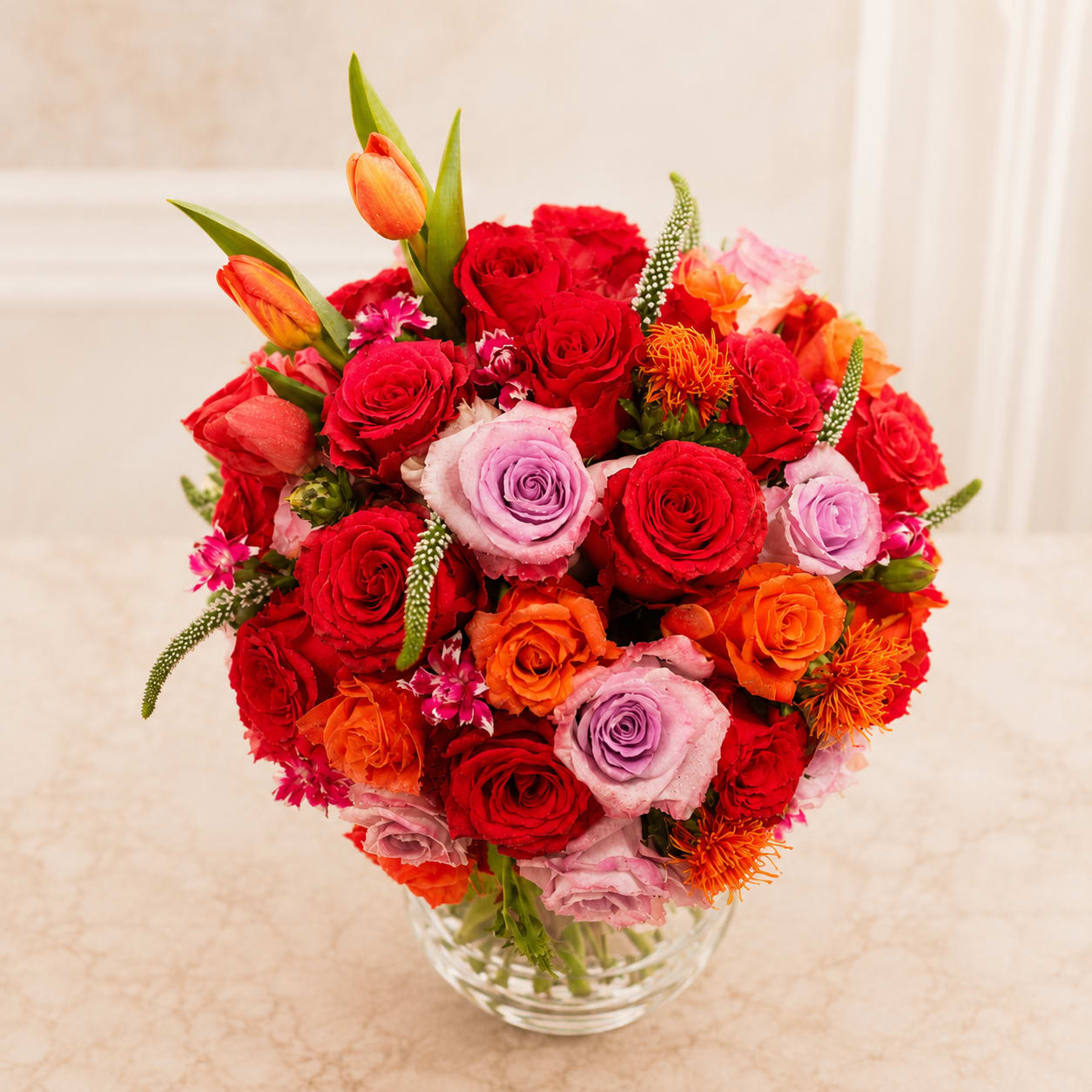 Loving bright blooms - Glass bowl with submerged flowers and a full twist of summer bright blooms. Beautiful arrangemnet for any occasions. Show your appreciation and love to someone special. Approximately 40 roses, and different types of colorful flowers.We are committed to delivering your important emotional sentiments on time and as fresh and beautiful as possible. Because of the nature, seasonality, and regional availability of flowers it is sometimes necessary to make substitutions of equal or greater value. We will make every effort to maintain the "look and feel" of the arrangement by considering the overall shape, size, and style combinations