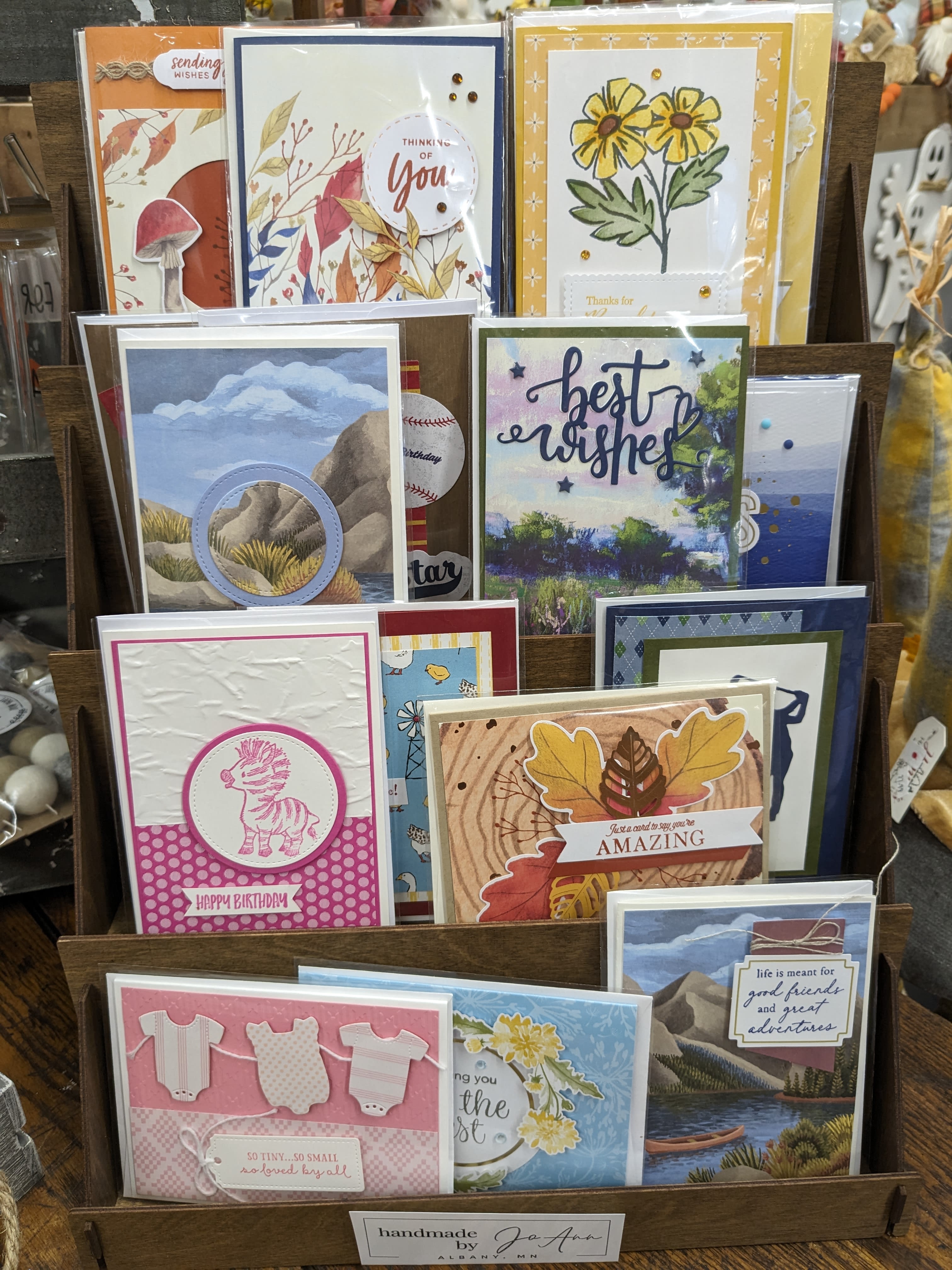 Display rack of handmade greeting cards with floral and birthday designs