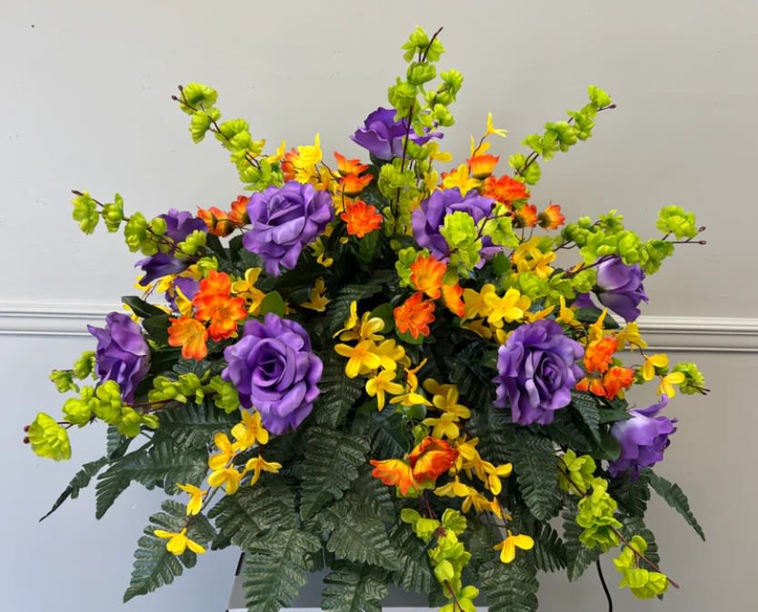 Colorful floral arrangement with purple, yellow, and orange blooms