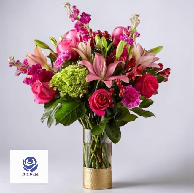 Midnight Orchard by Art and Flowers -    Composition, The arrangement follows a cascading or asymmetrical silhouette, creating a sense of movement. It utilizes a mix of focal blooms—likely large, velvety petals—complemented by delicate, airy filler elements.  Color Palette, A rich, monochromatic or jewel-toned scheme. Deep burgundies and soft mauves are offset by crisp white accents, all set against a backdrop of deep, forest-green foliage.  Texture, There is a beautiful tension between the dense, ruffled petals of the primary flowers and the sleek, waxy leaves of the greenery. The inclusion of thin, wispy stems adds a touch of whimsical fragility.  Mood, The overall vibe is moody yet elegant, evoking the feeling of a Dutch Masters still-life painting brought into a contemporary setting.  