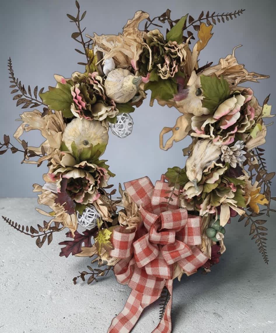 Dried floral wreath with a red plaid bow