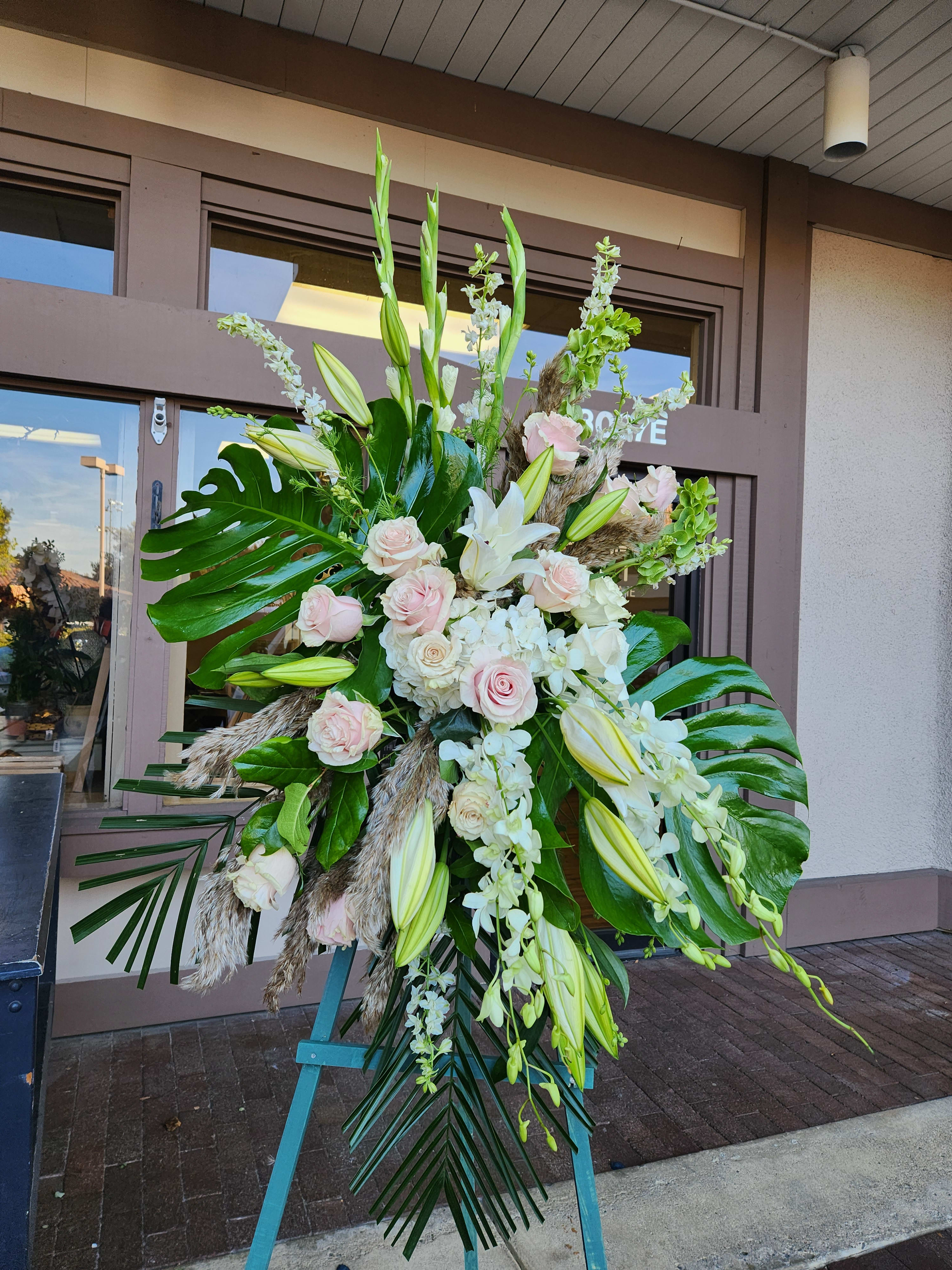 Large standing floral spray with white lilies and pale pink roses