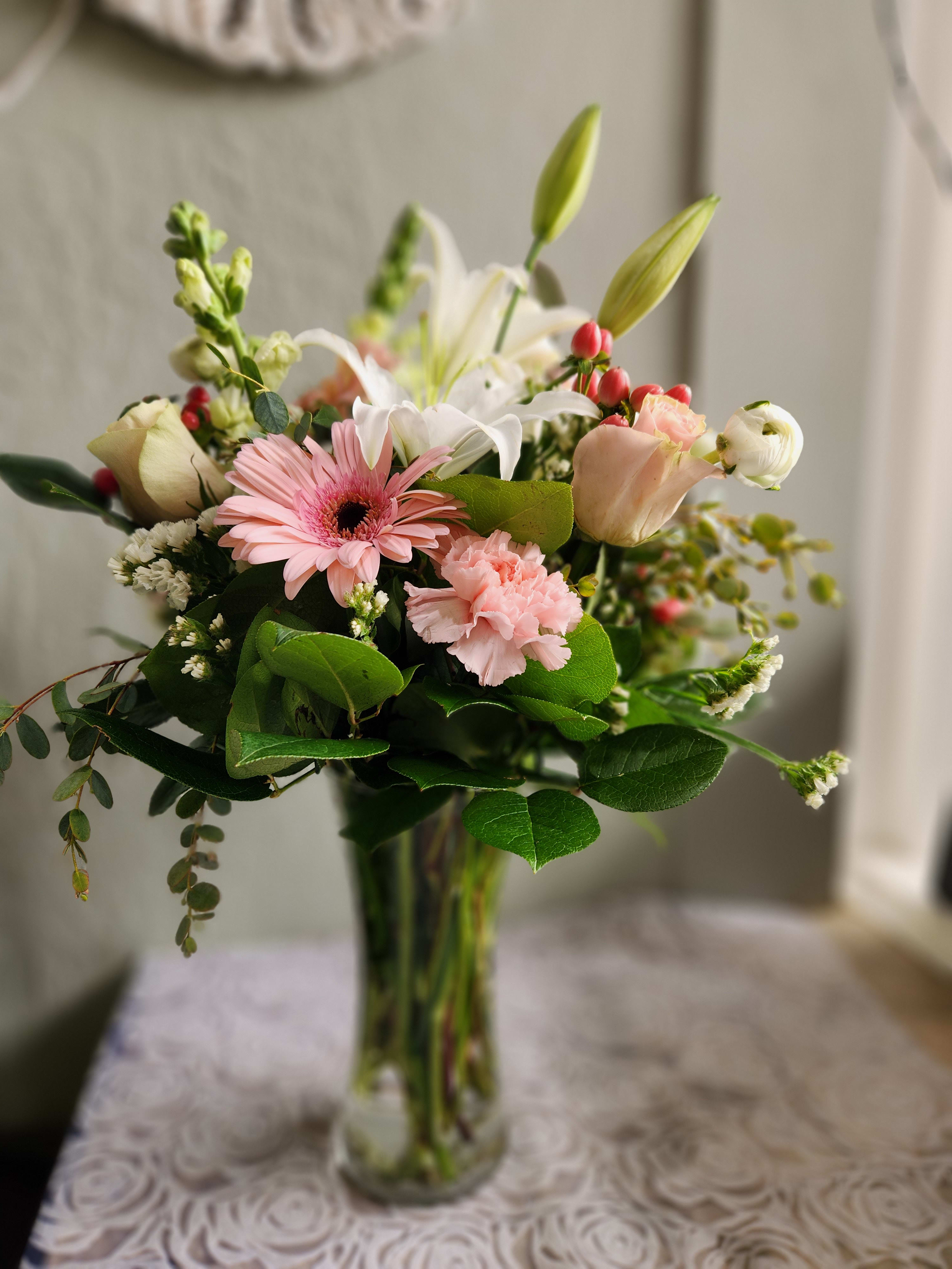 Pink and white mixed bouquet in a clear glass vase