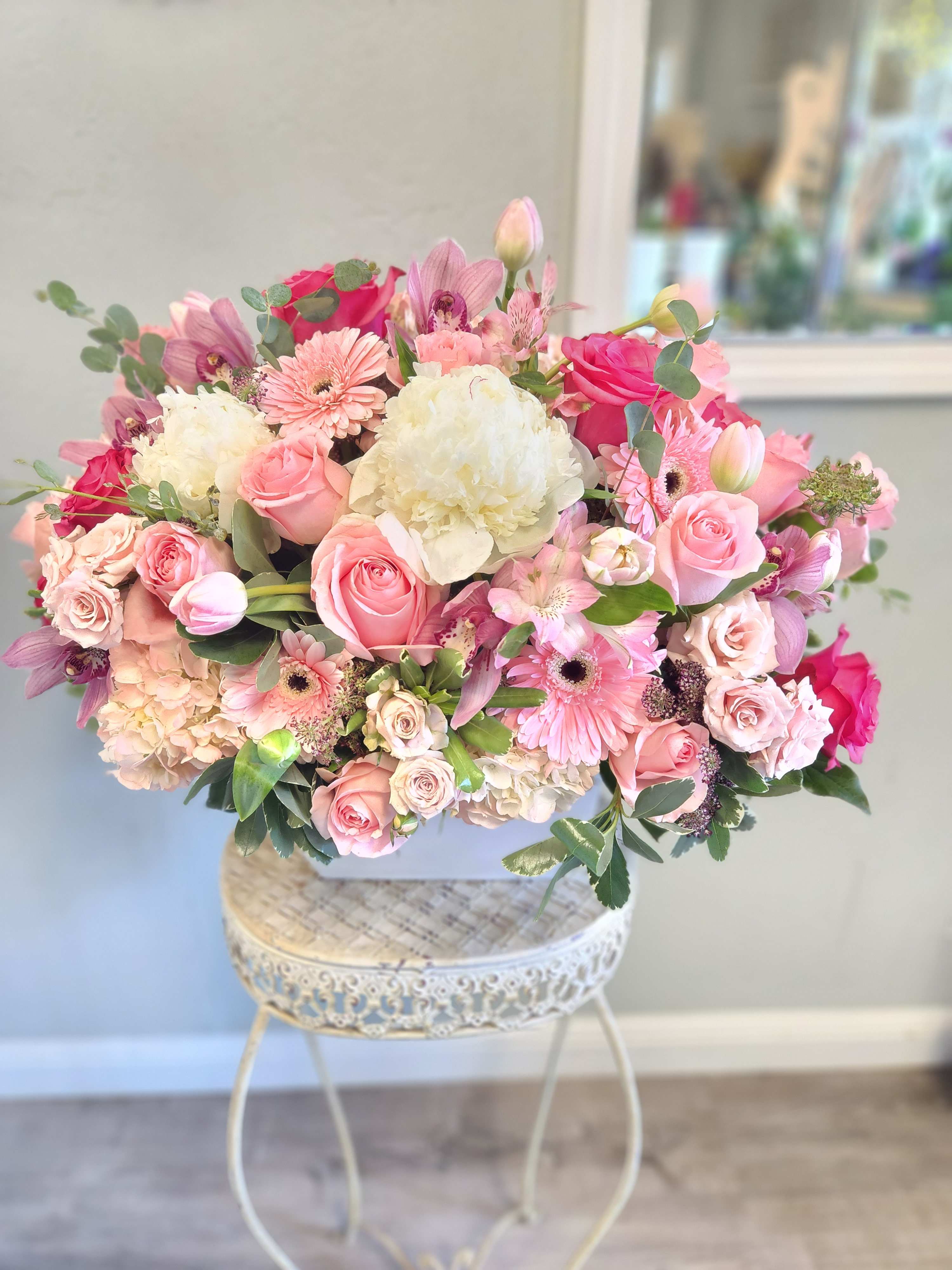 Pink and white mixed bouquet in a white container