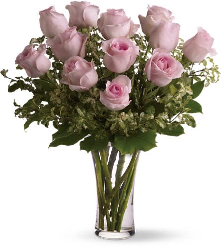 Pink roses arranged in a clear glass vase