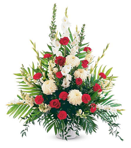 Red roses and white flowers in a white vase