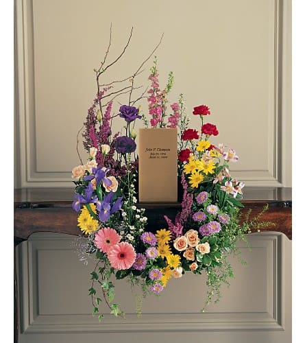 Colorful floral wreath around a cardboard box on a stand