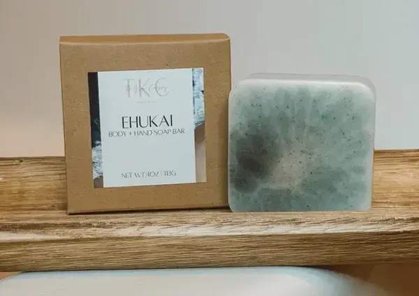 Boxed body and hand soap bar beside a green marbled soap bar