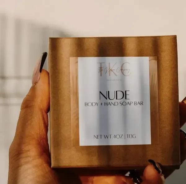 Hand holding a boxed nude body and hand soap bar