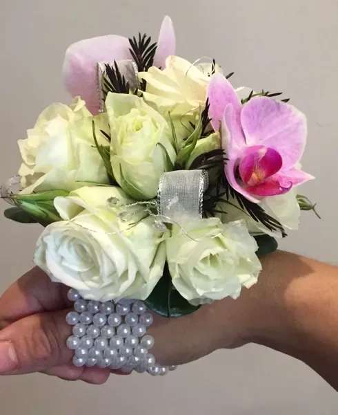 Sofie Corsage - This Sofie Corsage is very beautiful and elegant. It is made with white spray roses, and phalaenopsis orchids, with a satin ribbon and synthetic diamond on a pearl bracelet.
