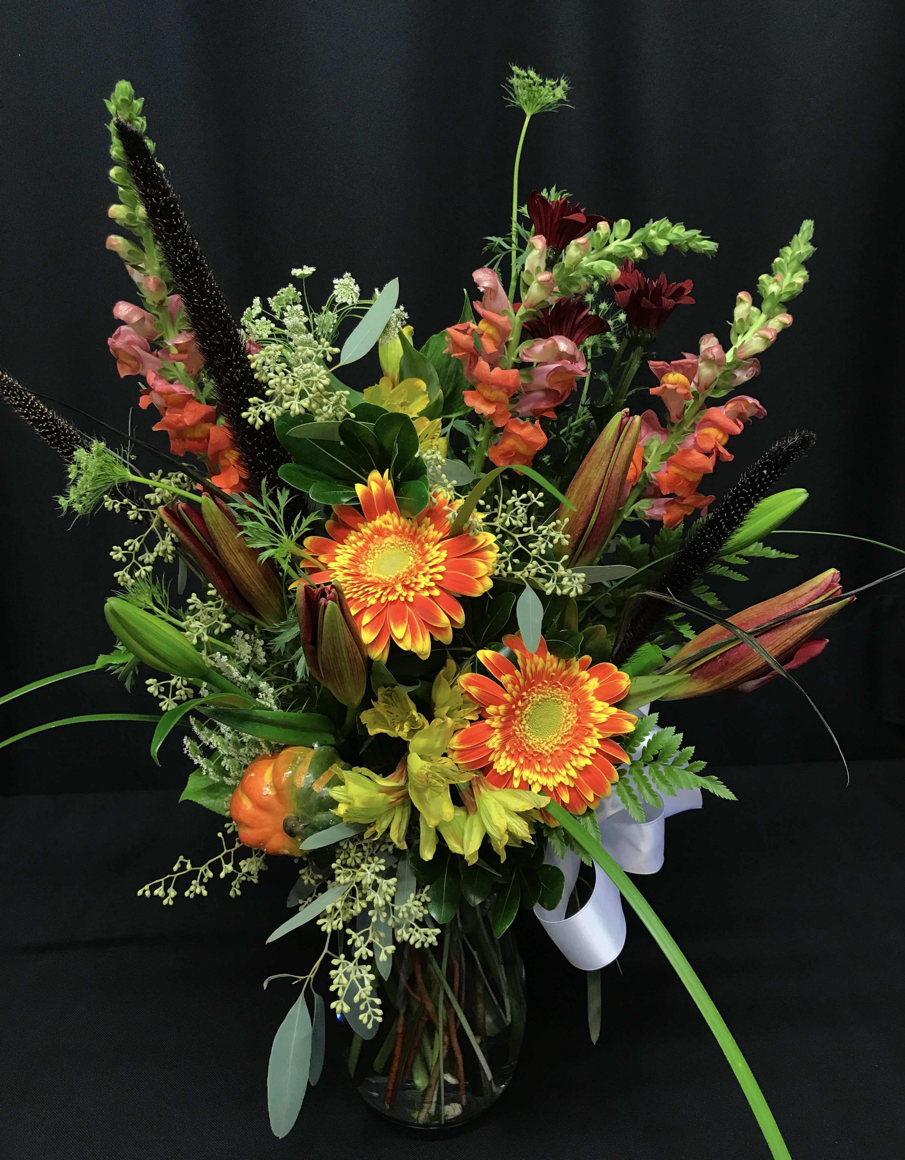Autumn mixed bouquet with lily buds - Bright flower bouquet full of fall flowers. Orange gerber daisies, lily buds about to open that will last and last.  Long lasting and fun for fall.  Medium tall vased arrangement makes a lovely thank you gift or sentiment.   Assortment may vary.