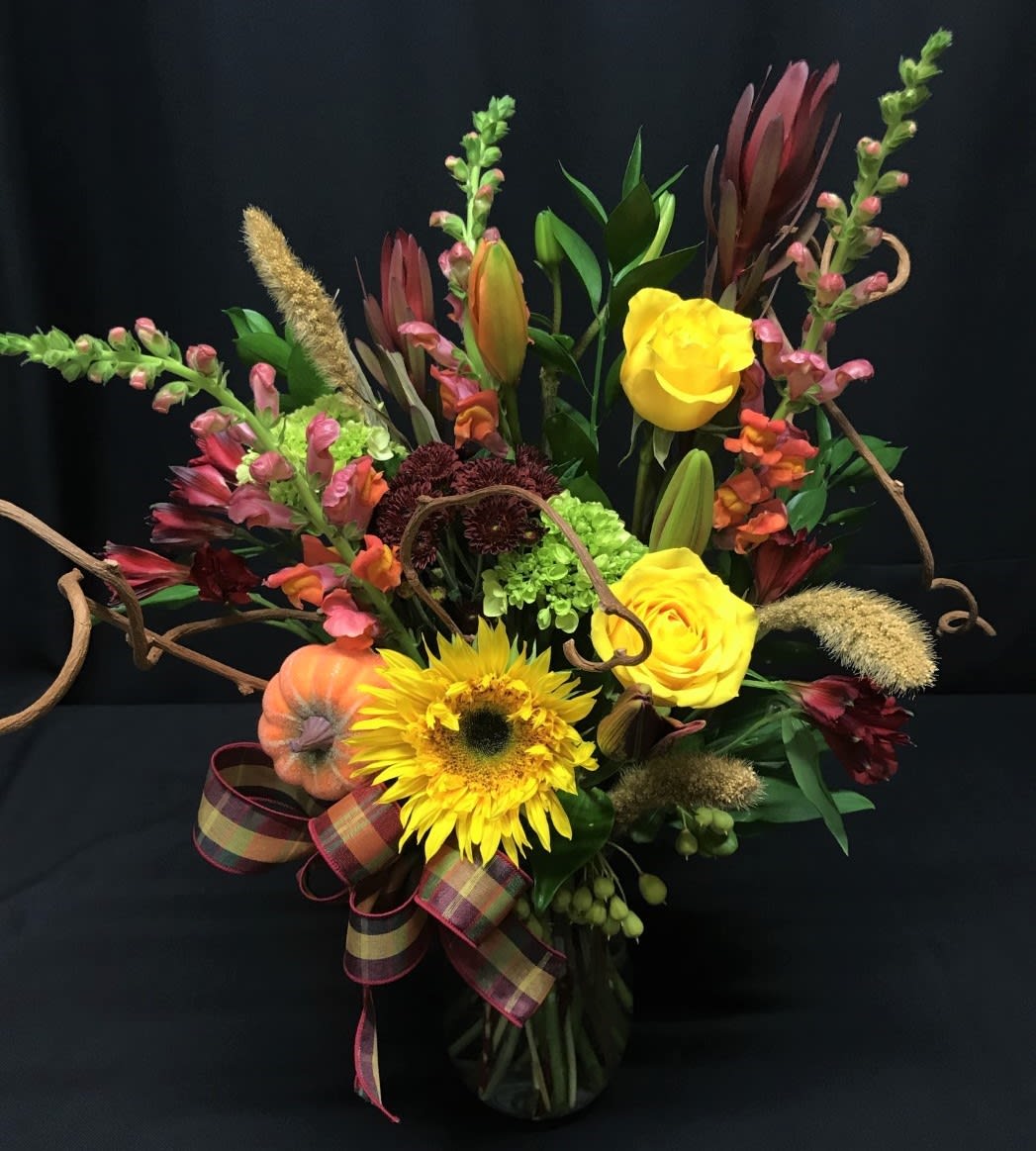 Thanksgiving Mixed Bouquet - Bright flower bouquet full of fall flowers. Sunflowers, lily buds about to open that will last and last.  Long lasting and fun for fall.  Medium tall vased arrangement makes a lovely thank you gift or sentiment.   Assortment may vary.