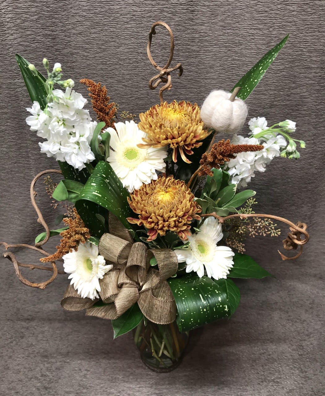Neutral Autumn Bouquet - Muted Bronze autumn tones are striking against this White bouquet for fall. Accents and flowers will vary. Branches and autumn accents bring this mixed bouquet to life!  Makes an excellent Host or Thank you Gift!