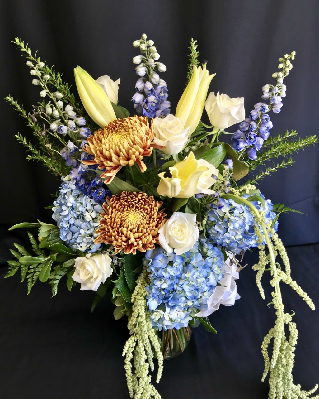 Uplifting Blues Mix - Soft shades of blue combine with seasonal best flowers. Assortment  will vary. This is a lovely choice for a pick-me-up, Get Well or Sympathy bouquet. No overpowering flowers or colors here, just comforting choices.
