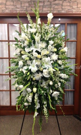 Large white floral standing spray on an easel