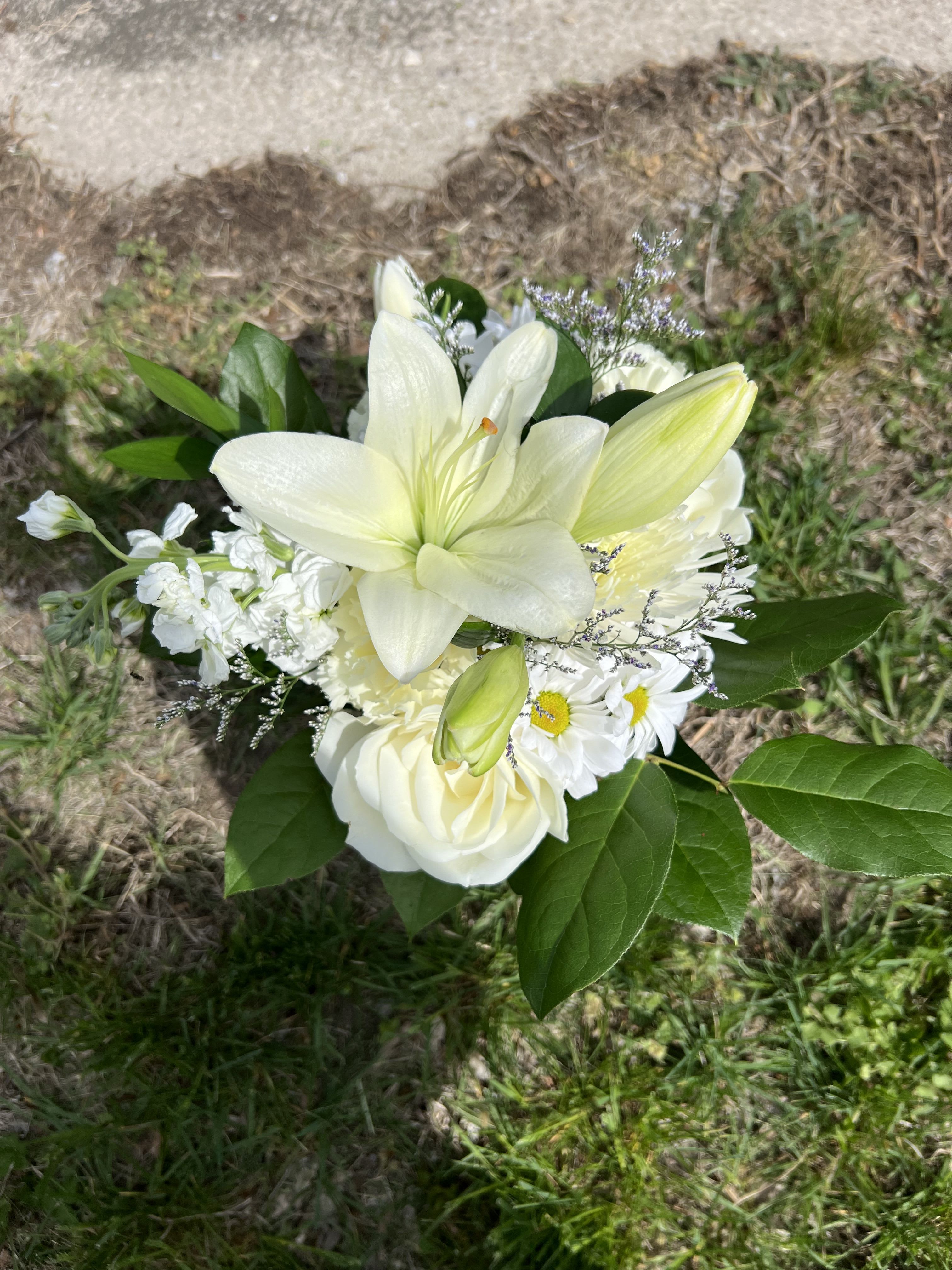 Mixed White Handheld Bouquet - An elegant hand-tied bouquet that will compliment any prom outfit. Filled with mixed flowers such as roses, daisies, and lilies. *Vase not included*