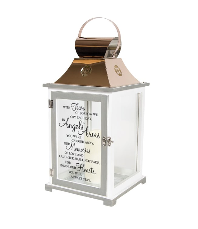 White memorial lantern with metallic top, handle, and remembrance quote on the glass door