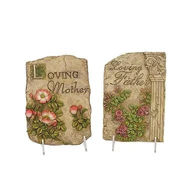 Two memorial plaques with floral reliefs and engraved text
