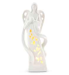White angel figurine with yellow lights inside