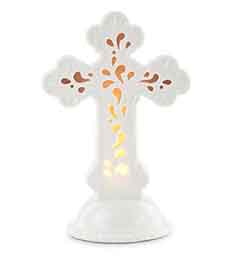 White cross-shaped floral display with orange and yellow accents