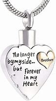 Heart-shaped pendant with engraved memorial text and a smaller heart inset