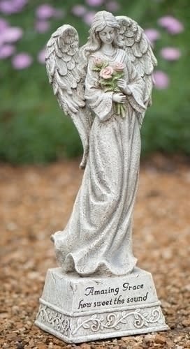 Angel statue holding pink roses with engraved text on the base