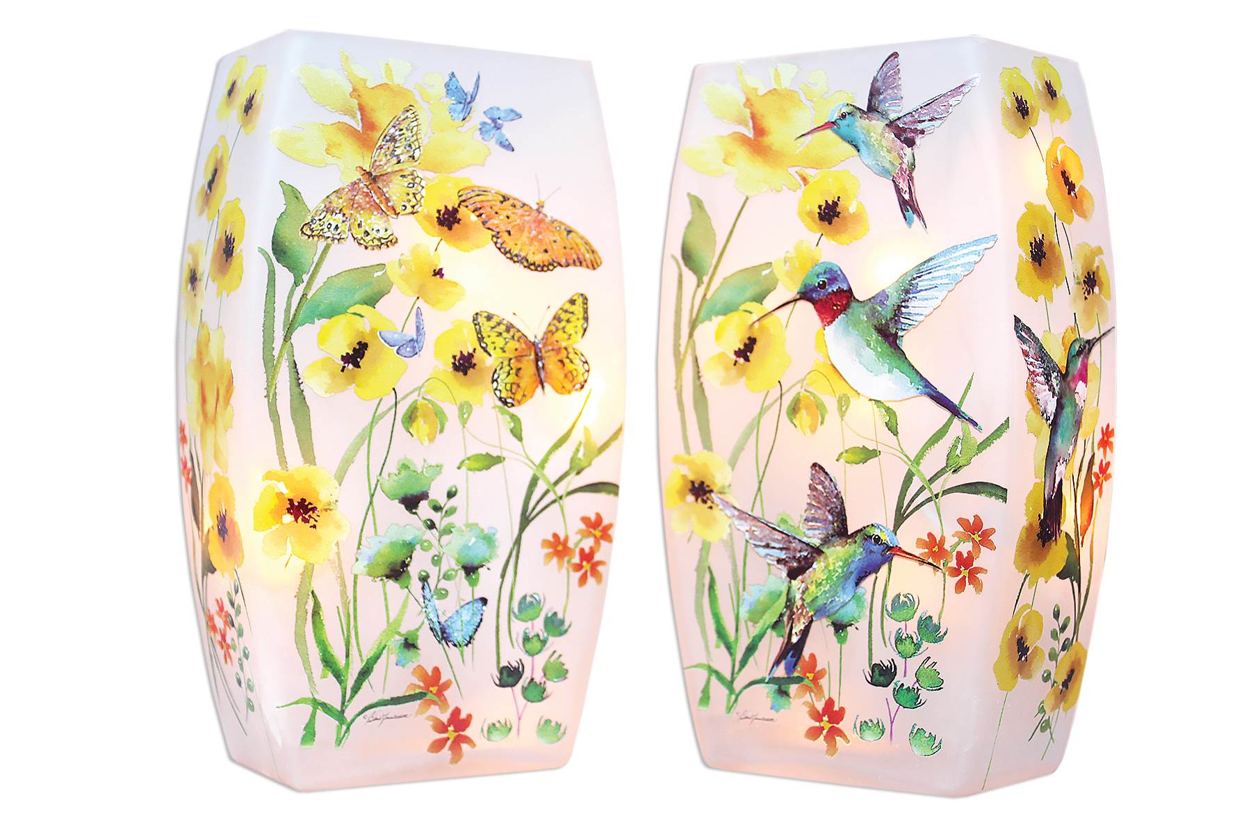 Pair of pink glass candle holders with yellow flowers, butterflies, and hummingbirds