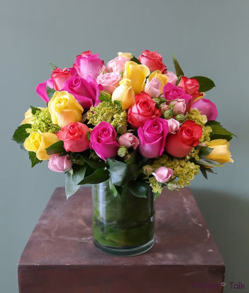 Bouquet of multicolored roses in a glass vase