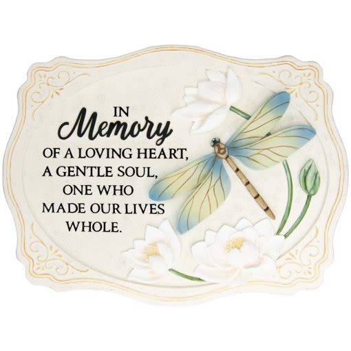 Memorial plaque with dragonfly and white flowers