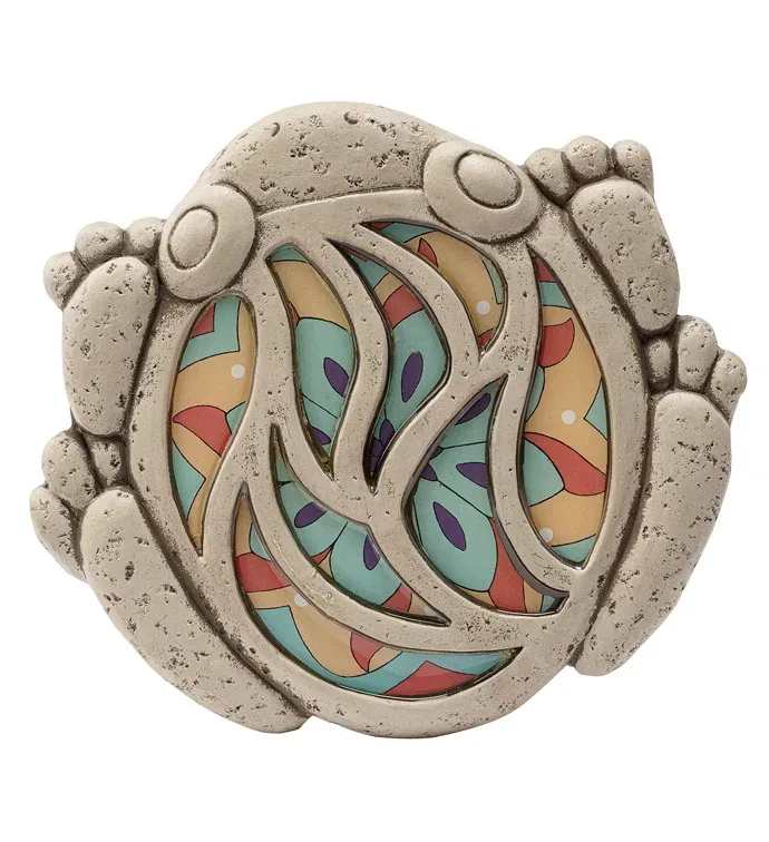 Mosaic Frog Steppingstone - A whimsical mosaic frog steppingstone brings a playful pop of color to garden décor and makes a charming gift for a housewarming, birthday, or "thinking of you" moment. This round stone plaque in the shape of a stylized frog can be placed among greenery or on a porch to make the person you're thinking of smile every time they step outside. The piece features a textured, weathered stone finish that outlines the frog's head, limbs, and back, with an openwork center that frames a brightly colored decorative insert. The colorful insert shows an abstract petal-and-leaf pattern in teal, peach, red and purple, creating a lively contrast between rustic stone and smooth, cheerful patterning. Sized to tuck neatly into a garden bed or sit beside indoor plants, it functions as both a decorative accent and a small sculptural focal point.  Perfect for gardeners, nature lovers, or anyone who enjoys playful outdoor accents, this frog steppingstone is the kind of small gift that makes someone feel noticed and delighted. It arrives ready to display-no planting required-and pairs especially well with peach, blue, or purple blooms for a coordinated look. 11" x9.75"
