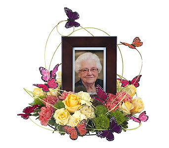 Framed portrait surrounded by roses and butterflies