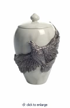 White ceramic urn with a sculpted bird decoration