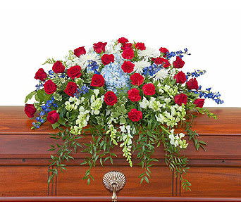 Red roses and mixed white-blue flowers arranged on a casket