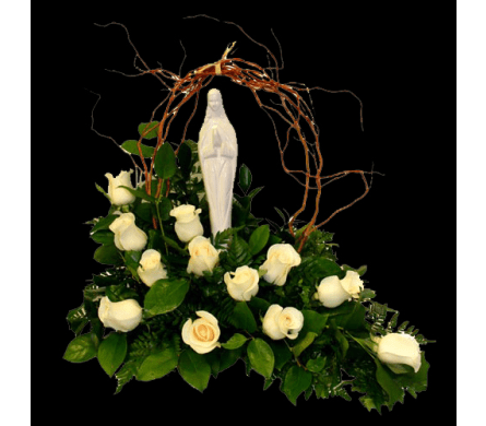 White roses arranged around a white statue under a twig arch