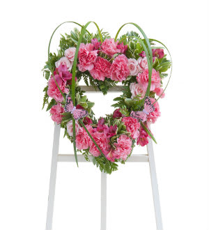 Pink carnation wreath on a white easel