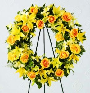 Yellow and orange floral wreath on a black stand
