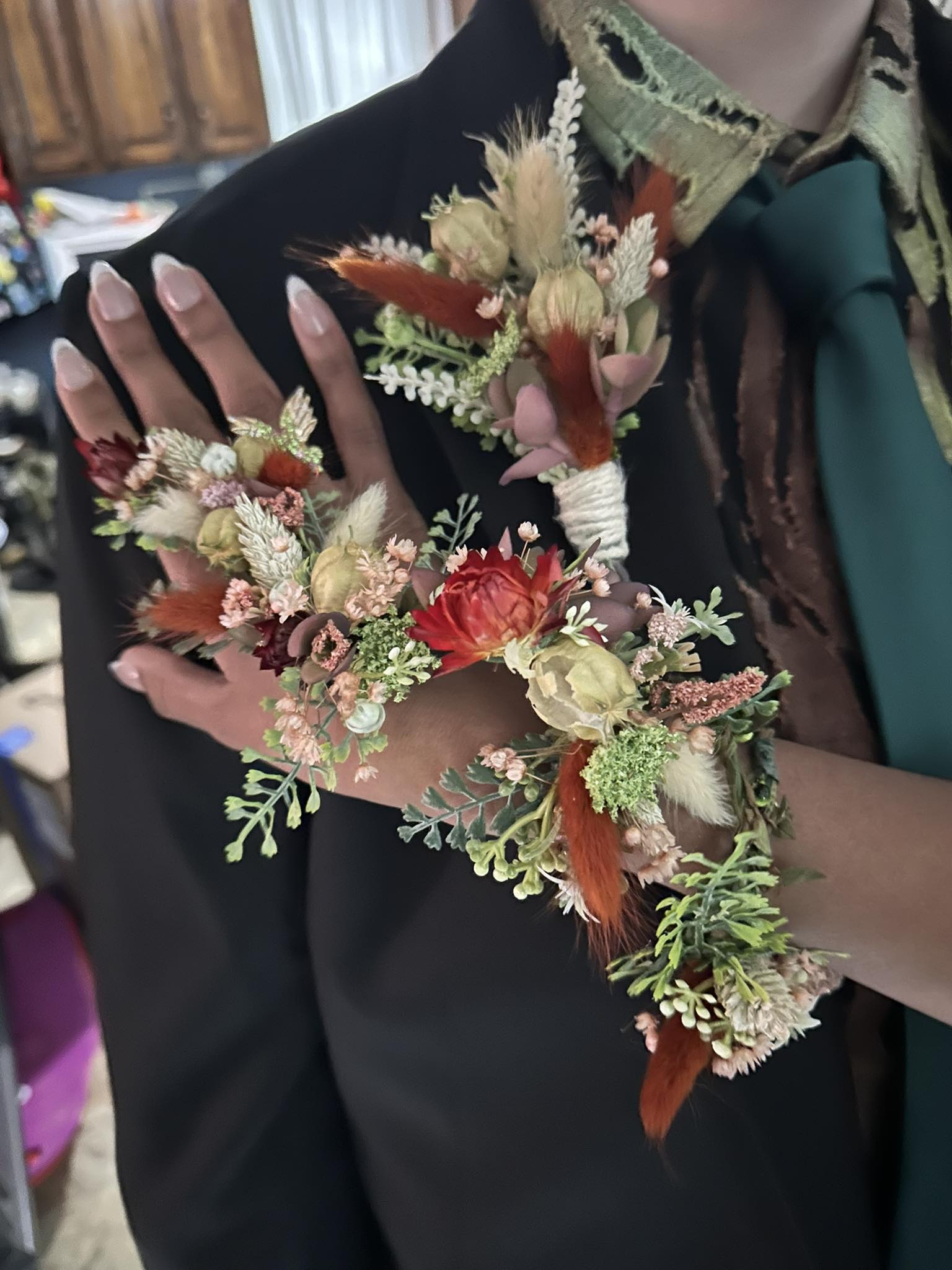 Floral wrist corsage and matching boutonniere with dried blooms and ribbon