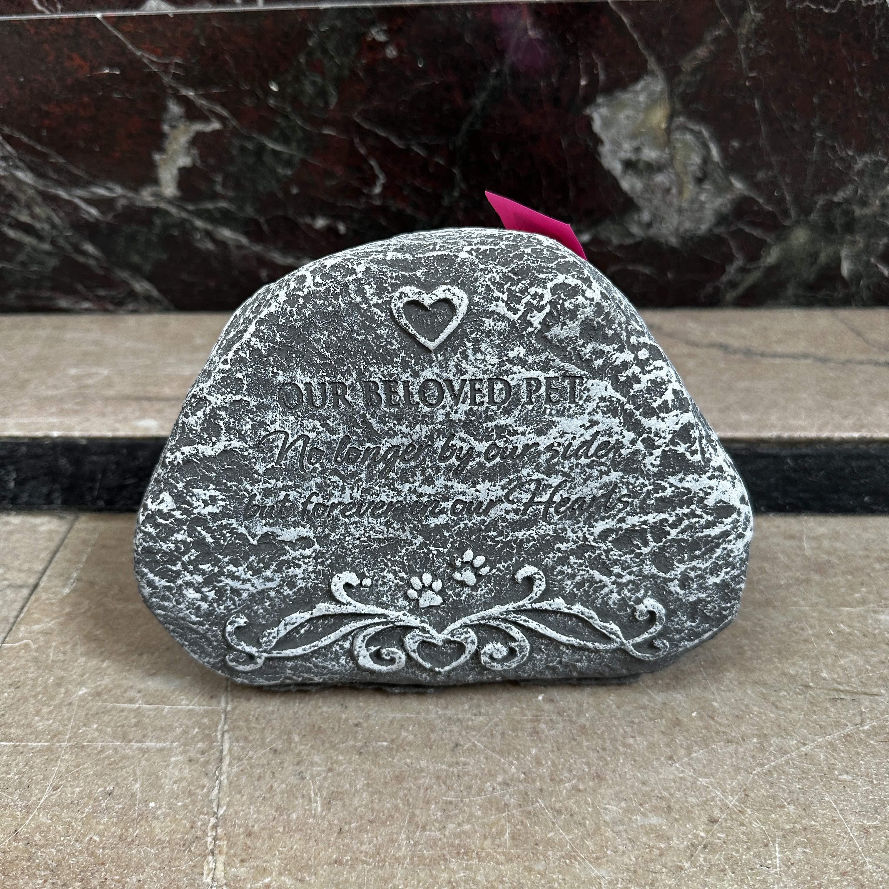 Engraved memorial stone with a heart and paw prints