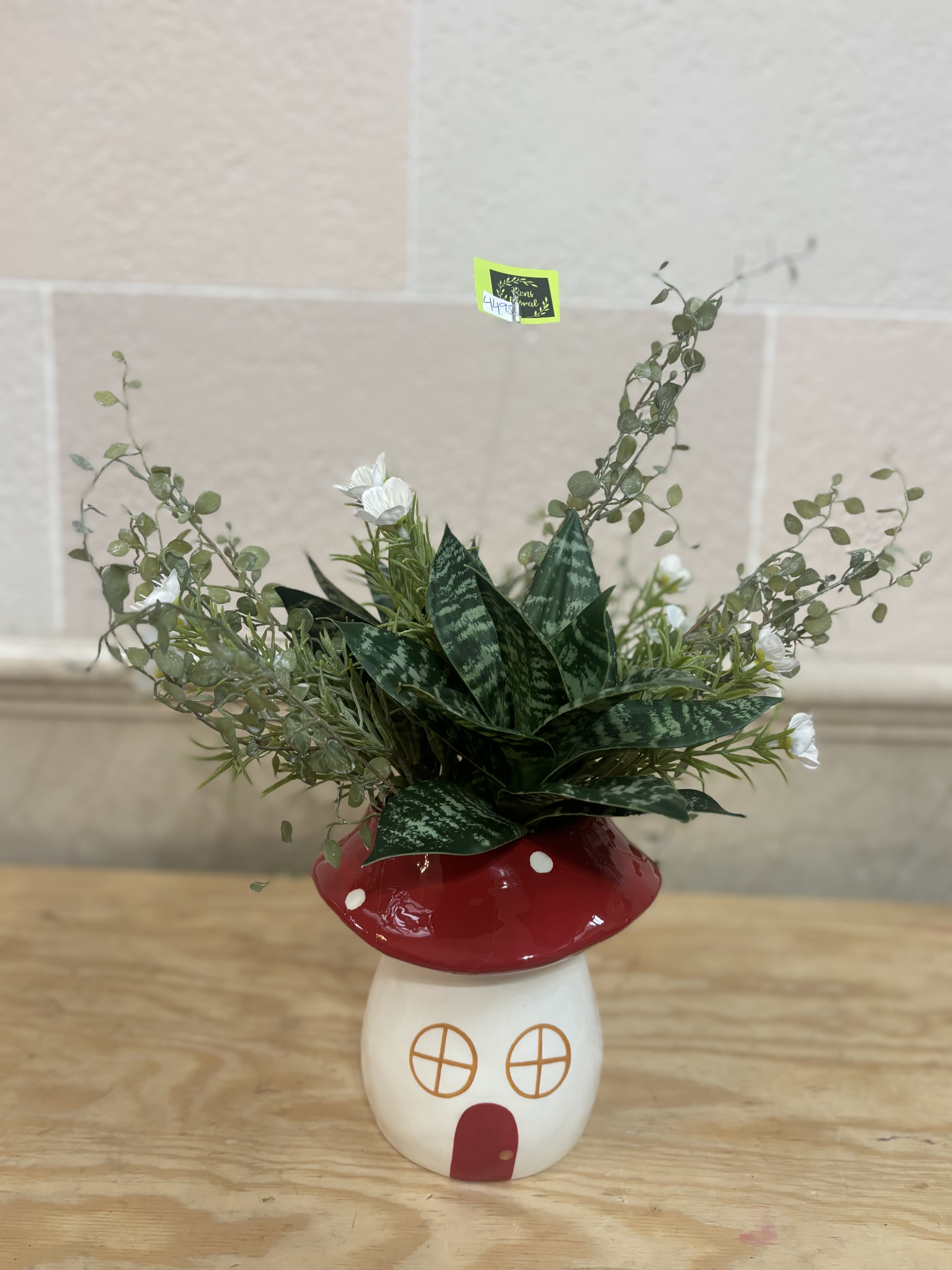 Potted succulent arrangement in a red-and-white mushroom planter