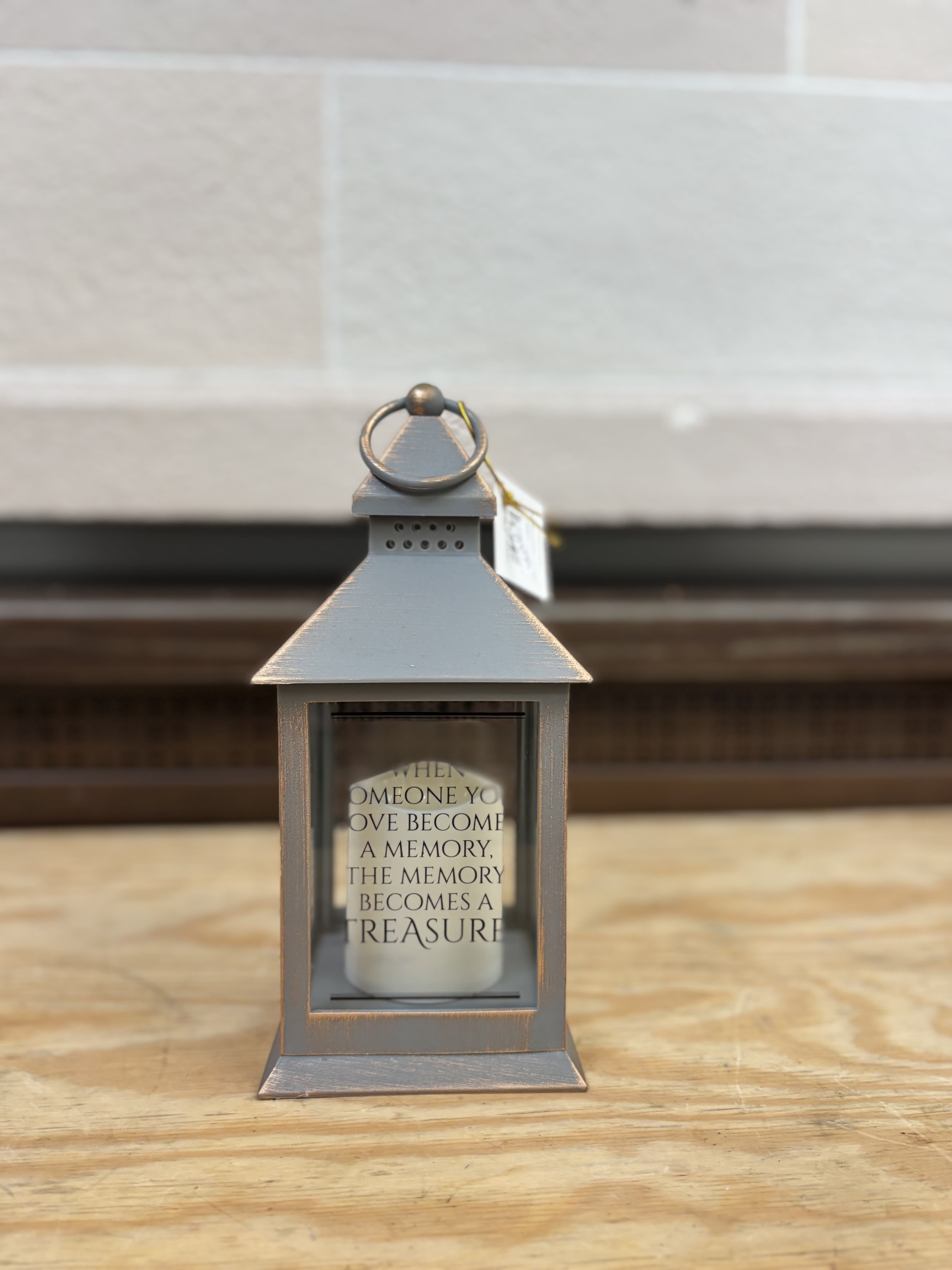 Gray memorial lantern with a candle inside