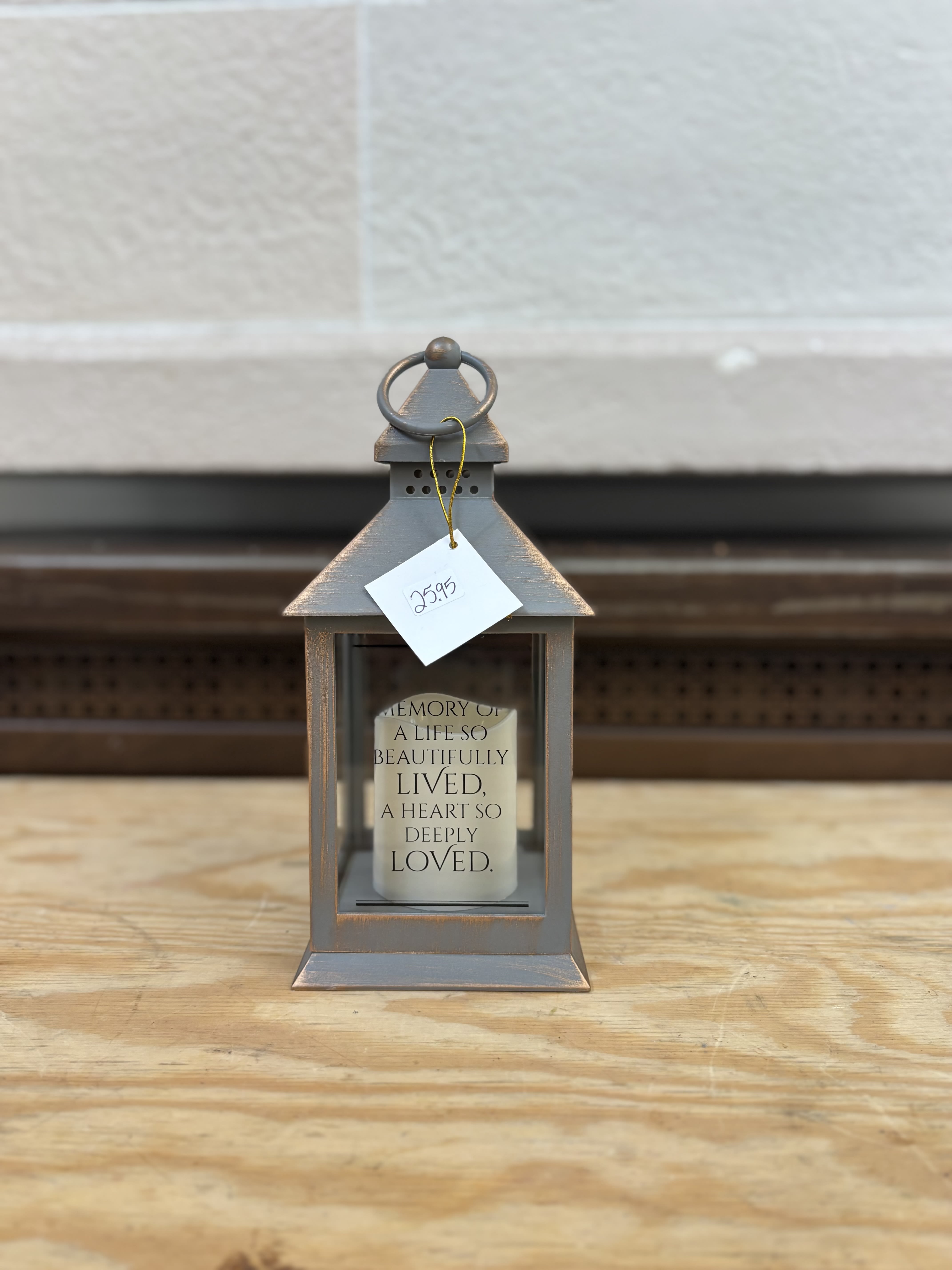 Gray lantern with a memorial candle inside