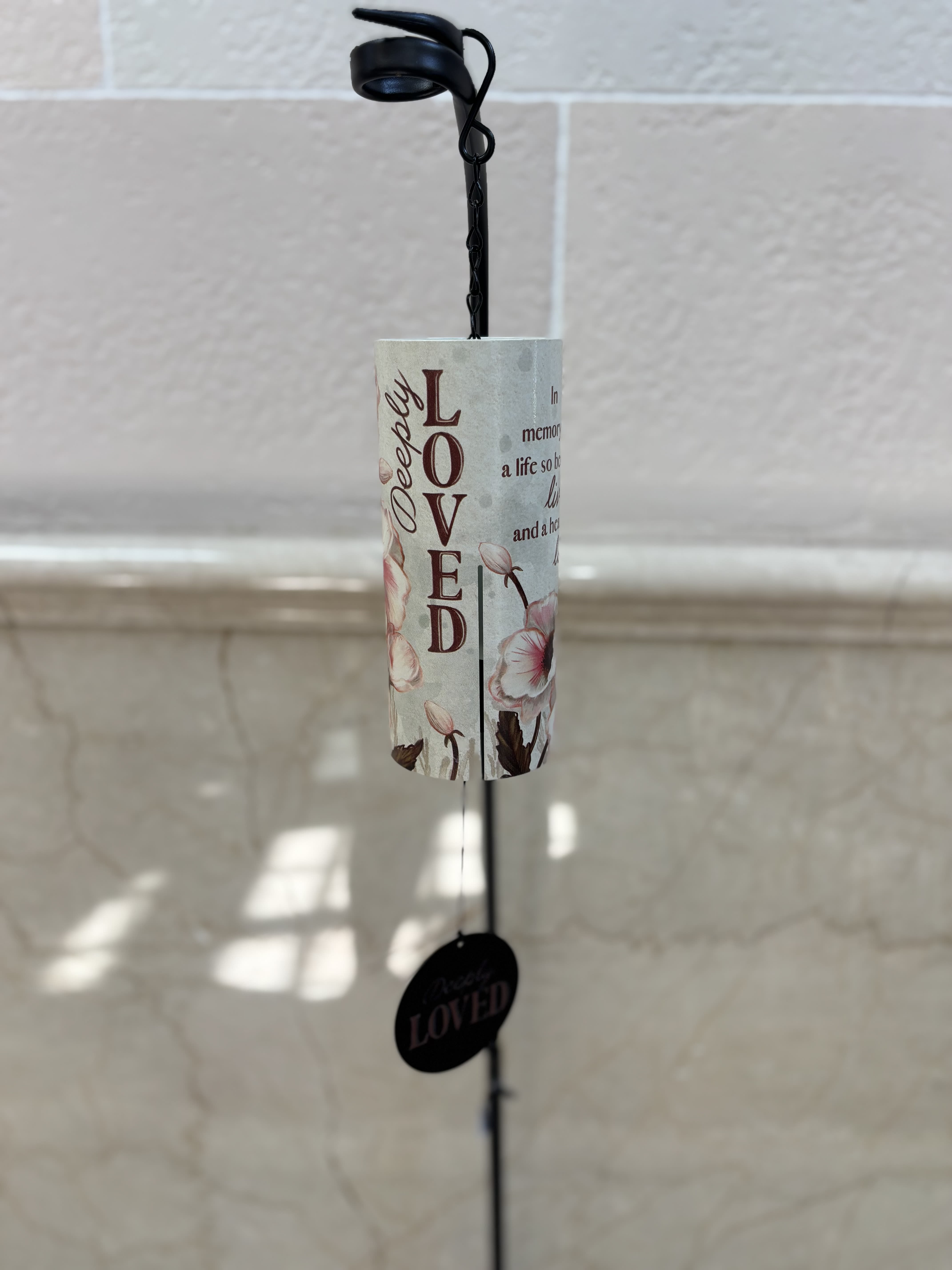 Hanging memorial wind chime with floral print and the word Loved
