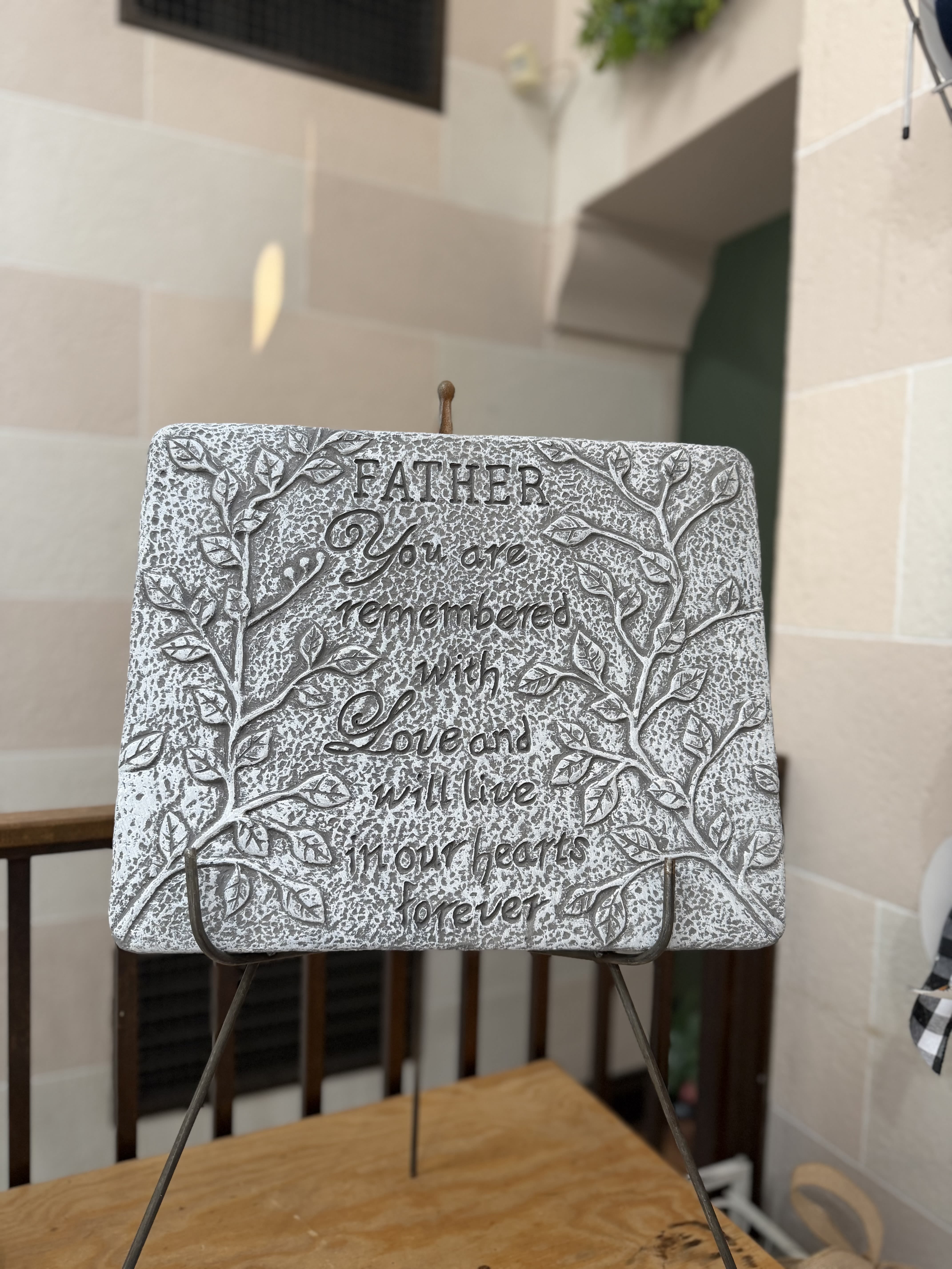 "Father" Stone  - A concrete stone on a stand with vine details.  Stone Reads: "Father you are remembered with love and will live in our hearts forever" 