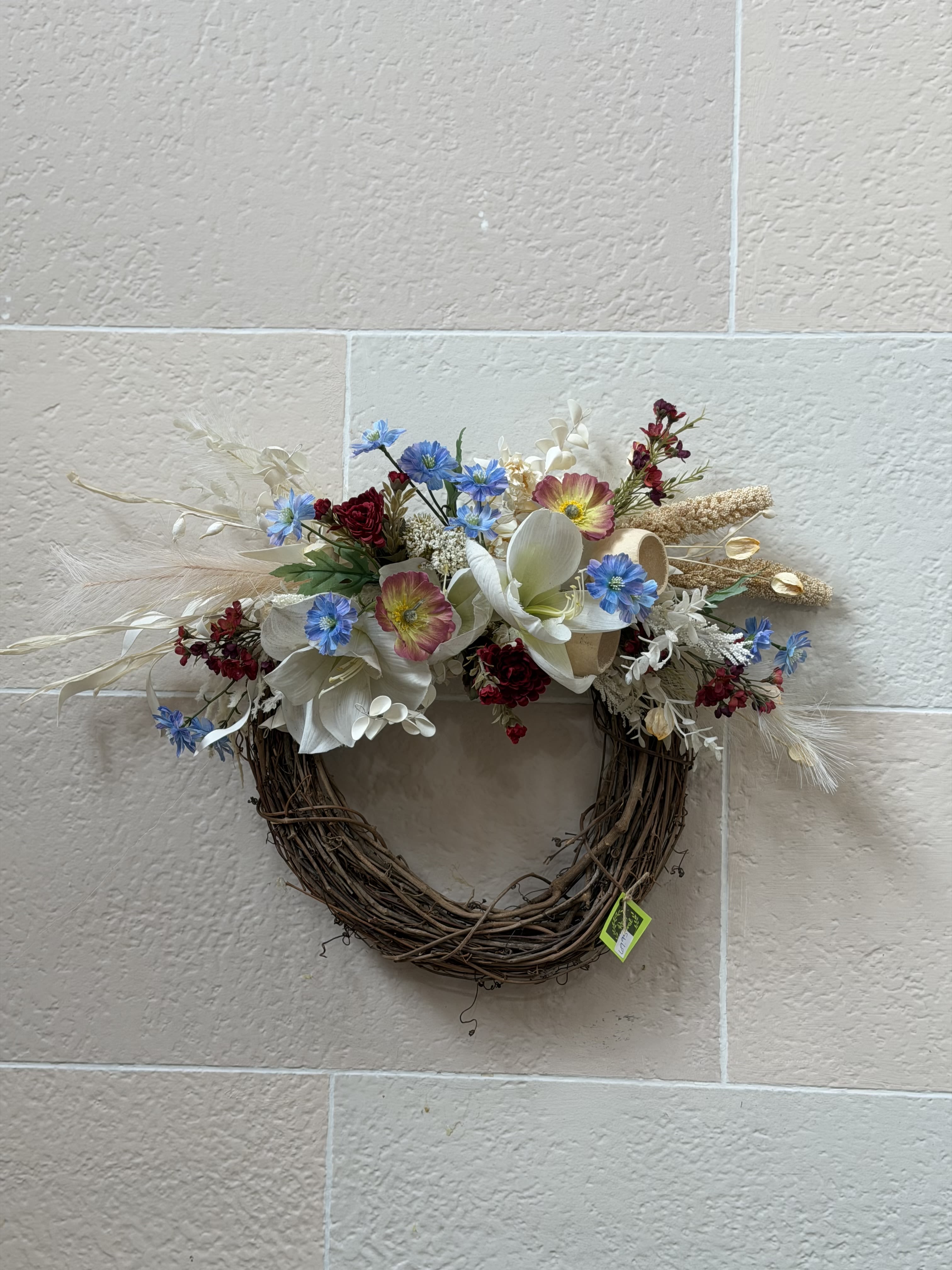 Fall Stick Wreath  - A stick wreath with white and cream artificial and dried flowers with pops of burgundy and blue artificial flowers. 
