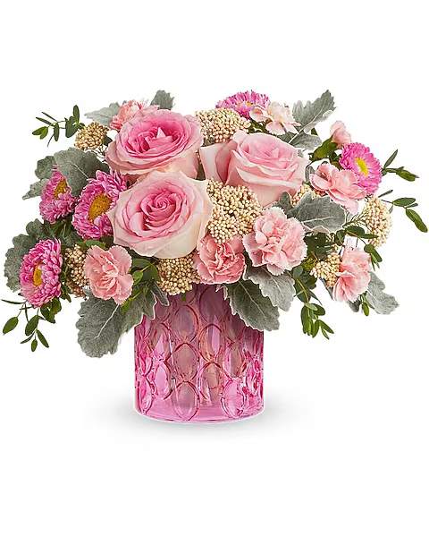 Pink roses and carnations in a pink glass vase