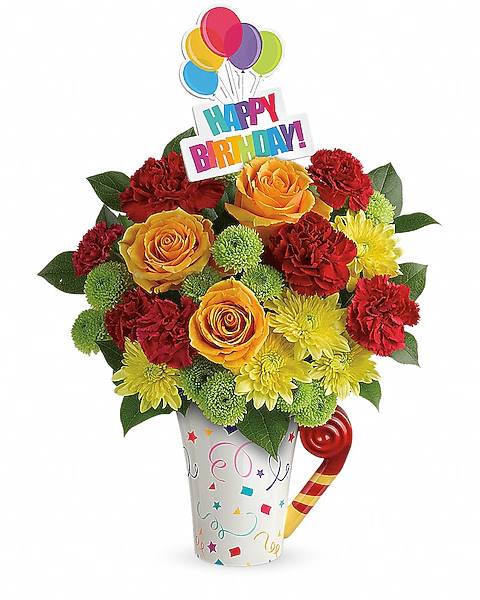 Birthday bouquet with roses, carnations, and a Happy Birthday topper in a decorated cup