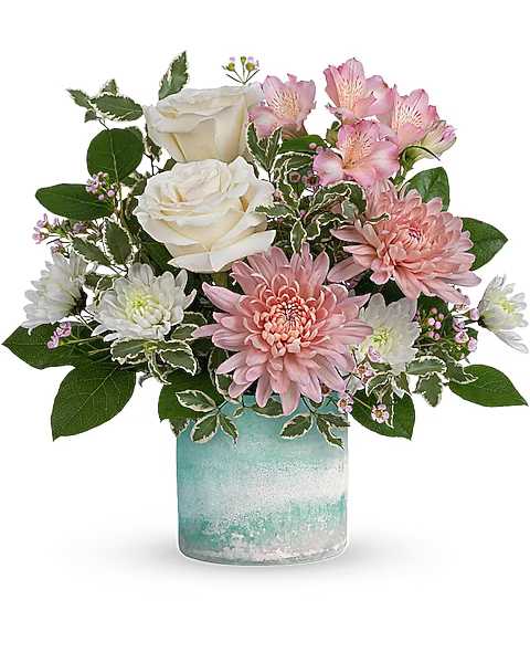 Pink and white flowers arranged in a blue glass vase